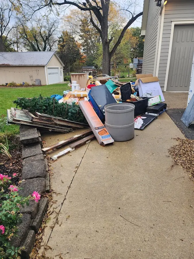 Dumpster being loaded with debris for Roofing Dumpster Rental in Newport